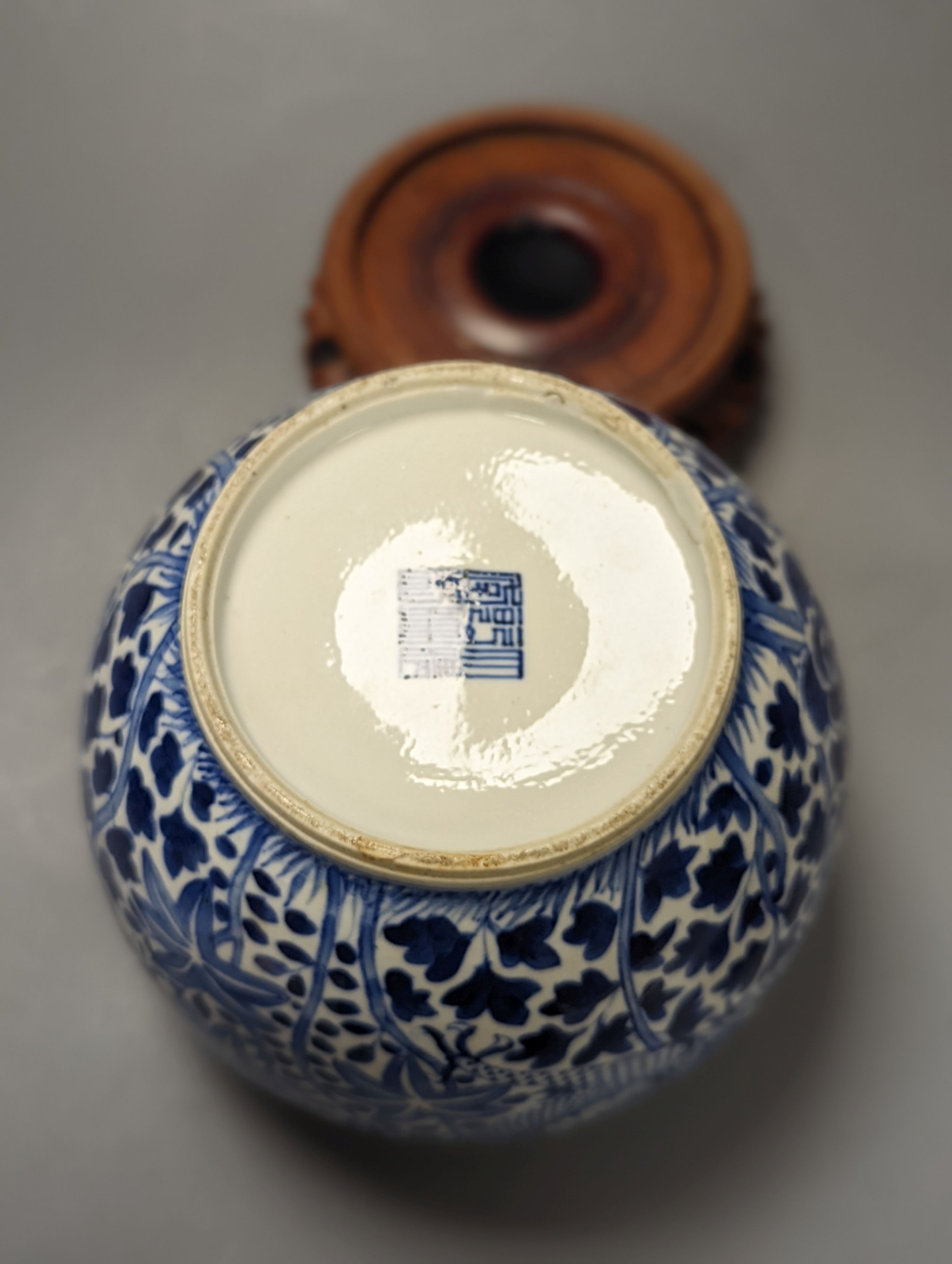 A Chinese blue and white ‘dragon’ jar, hardwood cover & stand, Qianlong mark but 19th century 22cm